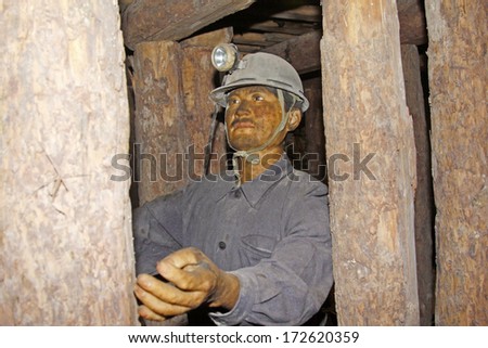TANGSHAN - OCTOBER 18: The Miners sculpture sculpture in 70 meters underground in the Kailuan national mine park on october 18, 2013, tangshan city, hebei province, China.