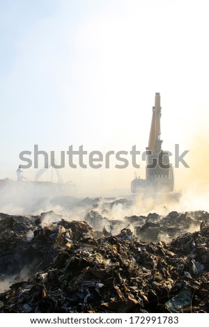 TANGSHAN - NOVEMBER 20: excavator clearing up rubbish after fire, November 20, 2013, tangshan city, hebei province, China.