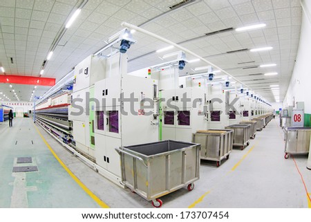 LUANNAN COUNTY - DECEMBER 20: The Spinning machinery and material handling carts in a production workshop, in the ZeAo spinning LTD., on December 20, 2013, Luannan county, hebei province, China.