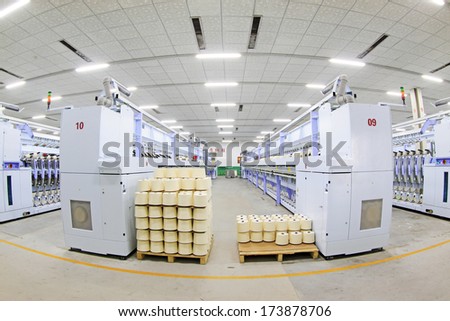 LUANNAN COUNTY - DECEMBER 20: The spinning machinery and cotton yarn in a production workshop, in the ZeAo spinning LTD., on December 20, 2013, Luannan county, hebei province, China.