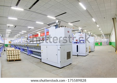 LUANNAN COUNTY, CHINA - DECEMBER 20: The spinning machinery and cotton yarn in a production workshop, in the ZeAo spinning LTD., on December 20, 2013, Luannan county, hebei province, China.