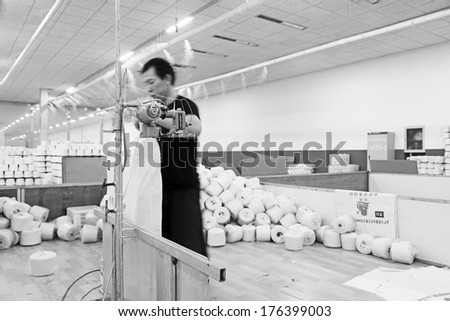 LUANNAN COUNTY - DECEMBER 20: Workers were packing cotton reel thread in a production workshop, in the ZeAo spinning LTD., on December 20, 2013, Luannan county, hebei province, China.