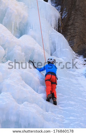 QINGLONG - JANUARY 18: Ice climbing enthusiasts use rope, climbing a frozen waterfall, on January 18, 2014, QingLong, hebei province, China.