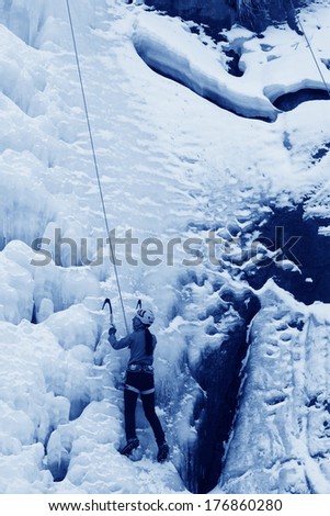 QINGLONG - JANUARY 18: The ice climbing enthusiasts use rope, climbing a frozen waterfall, on January 18, 2014, QingLong, hebei province, China.