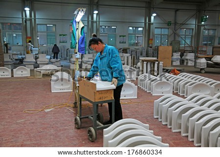 LUANNAN COUNTY - JANUARY 5: Workingwoman was testing the quality of the product, in the ZhongTong Ceramics Co., Ltd. January 5, 2014, Luannan county, Hebei Province, China.