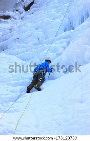 QINGLONG, CHINA - JANUARY 18: The ice climbing enthusiasts use rope, climbing a frozen waterfall, on January 18, 2014, QingLong, hebei province, China.