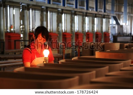 LUANNAN COUNTY - JANUARY 5: Women workers in the production line, in the ZhongTong Ceramics Co., Ltd. January 5, 2014, Luannan county, Hebei Province, China.