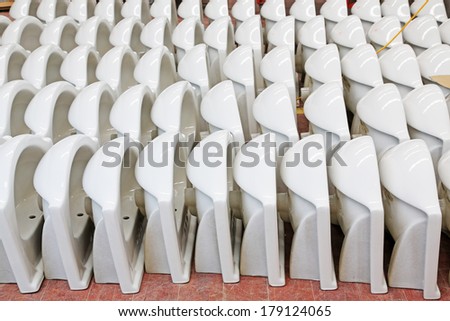 LUANNAN COUNTY, CHINA - JANUARY 5: Neat rows of ceramic closestool products assemblies in a warehouse, in the ZhongTong Ceramics Co., Ltd. January 5, 2014, Luannan county, Hebei Province, China.