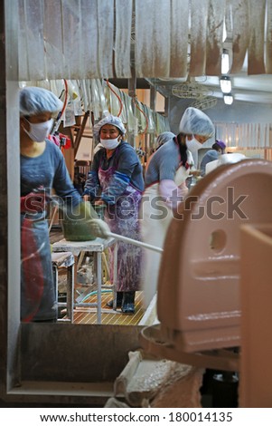 LUANNAN COUNTY - JANUARY 5: Busy women in a production line, in the ZhongTong Ceramics Co., Ltd. January 5, 2014, Luannan county, Hebei Province, China.