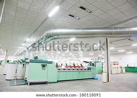 LUANNAN COUNTY - DECEMBER 20: Mechanical equipment was running in a production workshop, in the ZeAo spinning LTD., on December 20, 2013, Luannan county, hebei province, China.