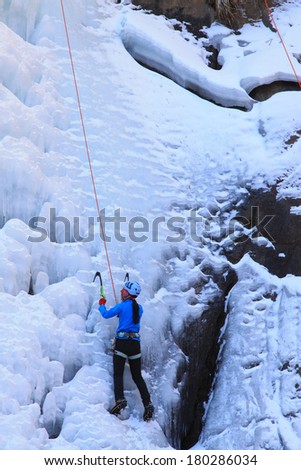QINGLONG, CHINA - JANUARY 18: Ice climbing enthusiasts use rope, climbing a frozen waterfall, on January 18, 2014, QingLong, hebei province, China.