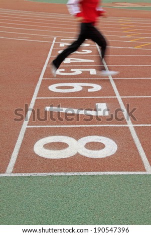 Walking man legs on runway in a sports ground in a middle school