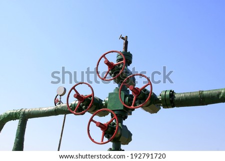 Red handwheel and oil pipeline in a oil mining area