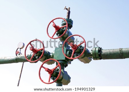 Red handwheel and oil pipeline in a oil mining area