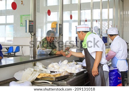 TANGSHAN - JUNE 18: workers buying food in a staff canteen, in a iron and steel co., on June 18, 2014, Tangshan city, Hebei Province, China