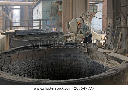TANGSHAN - JUNE 18: technical personnel maintenance kiln facilities in iron and steel co., on June 18, 2014, Tangshan city, Hebei Province, China