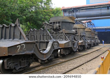 TANGSHAN - JUNE 18: Transport molten iron crucible vehicle in the steel mills, in a iron and steel co., on June 18, 2014, Tangshan city, Hebei Province, China