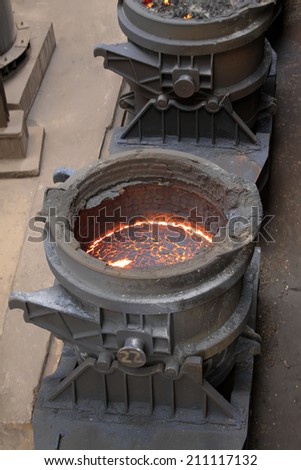 Hot molten iron in the crucible, closeup of photo