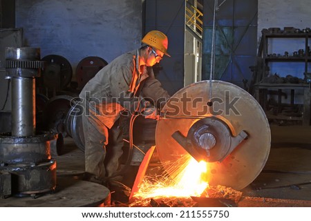 TANGSHAN - JUNE 19: workers welding metal parts in a workshop, on June 19, 2014, Tangshan city, Hebei Province, China