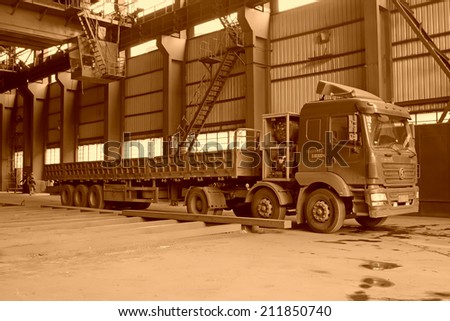 TANGSHAN - JUNE 19: Transport steel ingot heavy truck in iron and steel co., on June 19, 2014, Tangshan city, Hebei Province, China