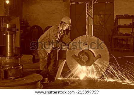 TANGSHAN - JUNE 19: workers welding metal parts in a workshop, on June 19, 2014, Tangshan city, Hebei Province, China