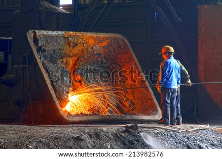 TANGSHAN - JUNE 20: Workers repairing mechanical components in steel plant, on June 20, 2014, Tangshan city, Hebei Province, China