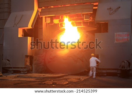 TANGSHAN - JUNE 19: steel mills converter workers tense work, on June 19, 2014, Tangshan city, Hebei Province, China