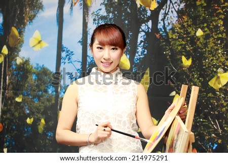 TANGSHAN CITY - AUGUST 22: Painting model in a commercial activity in a shop, on august 22, 2014, Tangshan City, Hebei Province, China