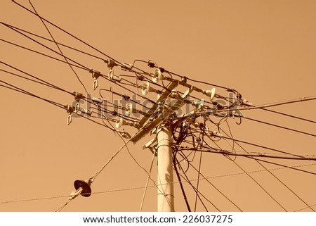 Messy porcelain and electric wires on the poles