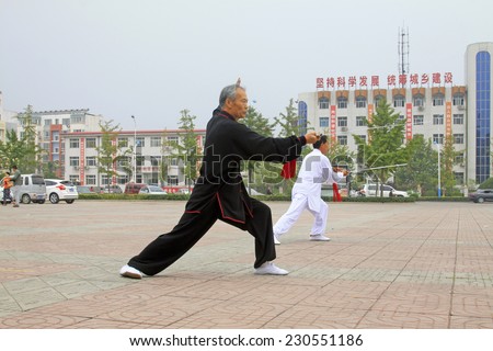 LUANNAN COUNTY - SEPTEMBER 20: Old man Fencing performance in a square on September 20, 2014, Luannan county, Hebei Province, China