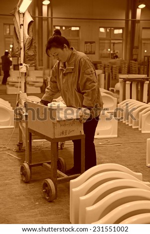 LUANNAN COUNTY - JANUARY 5: The workingwoman was testing the quality of the product, in the ZhongTong Ceramics Co., Ltd. January 5, 2014, Luannan county, Hebei Province, China.