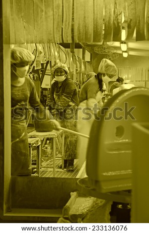 LUANNAN COUNTY - JANUARY 5: The busy women in a production line, in the ZhongTong Ceramics Co., Ltd. January 5, 2014, Luannan county, Hebei Province, China.
