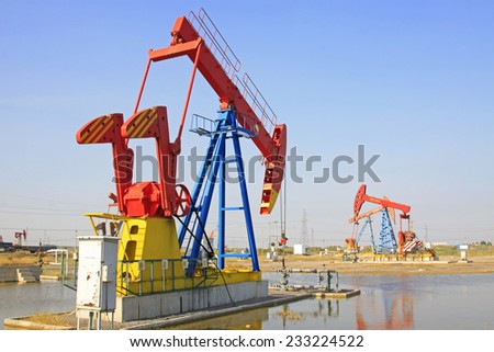 CAOFEIDIAN - SEPTEMBER 27: crank balanced beam pumping unit in the JiDong oilfield, on September 27, 2014, Caofeidian City, hebei province, China.