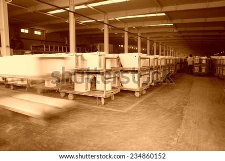 LUANNAN COUNTY - JANUARY 5: The worker and ceramic closestool products assemblies in a warehouse, in the ZhongTong Ceramics Co., Ltd. January 5, 2014, Luannan county, Hebei Province, China.