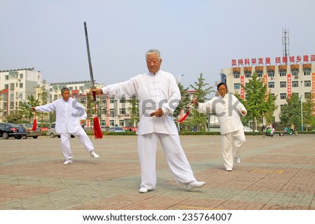 LUANNAN COUNTY - SEPTEMBER 20: Old men fencing performance in a square on September 20, 2014, Luannan county, Hebei Province, China