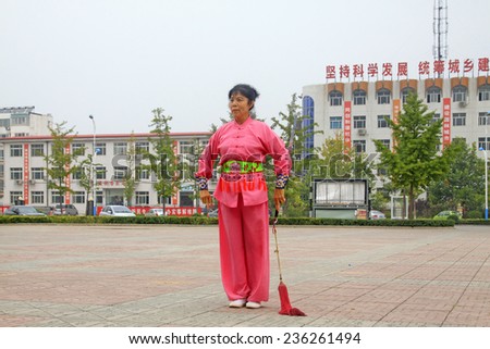 LUANNAN COUNTY - SEPTEMBER 20: Old woman Fencing performance in a square on September 20, 2014, Luannan county, Hebei Province, China