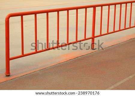 Orange metal railings, closeup of photo