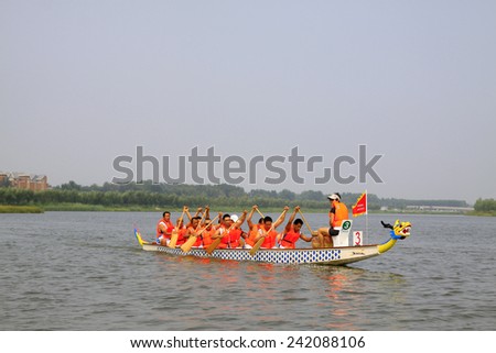 LUANNAN COUNTY - AUGUST 8: dragon boat race scene in the river on august 8, 2014, Luannan County, Hebei Province, China.