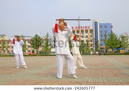 LUANNAN COUNTY - SEPTEMBER 20: Old men fencing performance in a square on September 20, 2014, Luannan county, Hebei Province, China