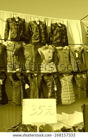 customer and vendor in bargaining, before a clothing stalls, on january 28, 2014, Luannan county, Hebei province, China.