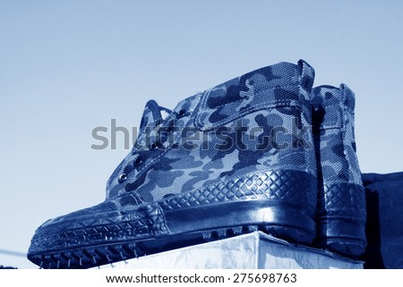 men camouflage rubber shoes in the booth
