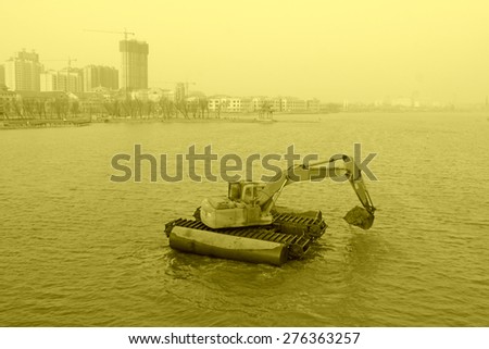 Excavator working in the water on march 22, 2014, luannan county, hebei province, China