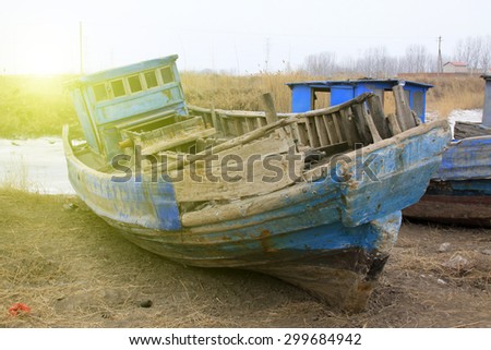 Broken boat on land, closeup of photo