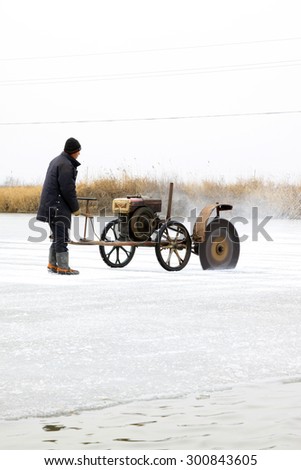 LUANNAN COUNTY - JANUARY 24: Farmers were cutting river ice on January 24, 2015, Luannan County, Hebei Province, China