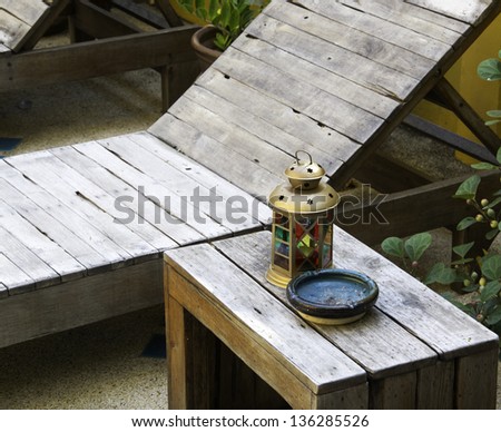 colorful lamp and Ashtray on wood table near swimming pool