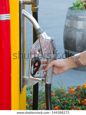 Close-up of a hand woman and Fuel nozzle