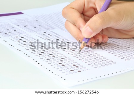 Student filling out answers to purple answer sheet with purple pencil