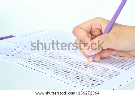 Student filling out answers to purple answer sheet with purple pencil