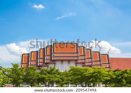 Temple roof and the layer of the tree on the blue sky.