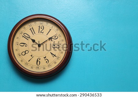Antique clocks vintage retro styles Hanging on the wall of blue, with space for text.